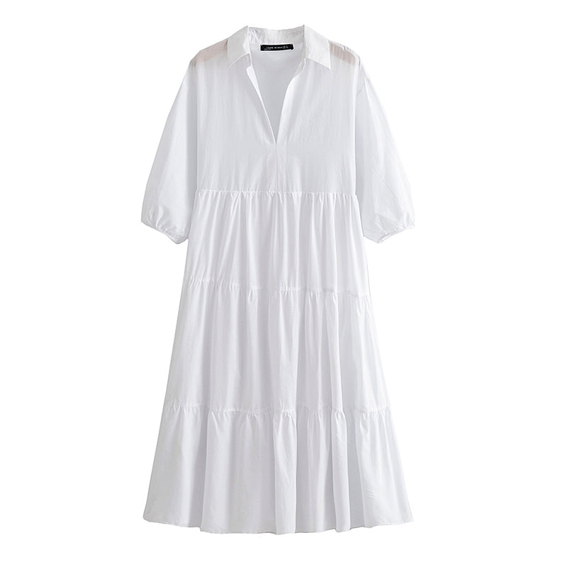 Biała sukienka o średniej długości z długim rękawem