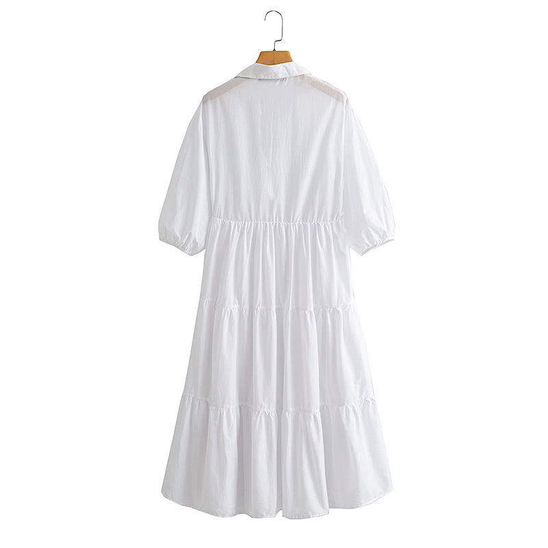 فستان أبيض متوسط الطول بأكمام طويلة