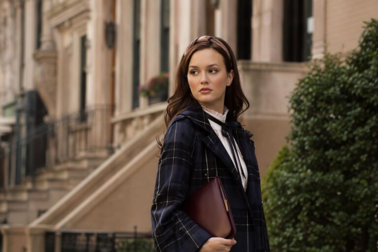 Blair Waldorf style fall outfit with plaid skirt, headband, and tailored coat on a city street