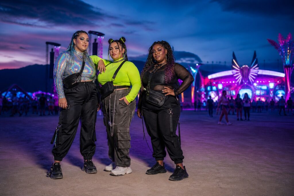 plus size rave outfits with three models in iridescent, neon, and black festival looks