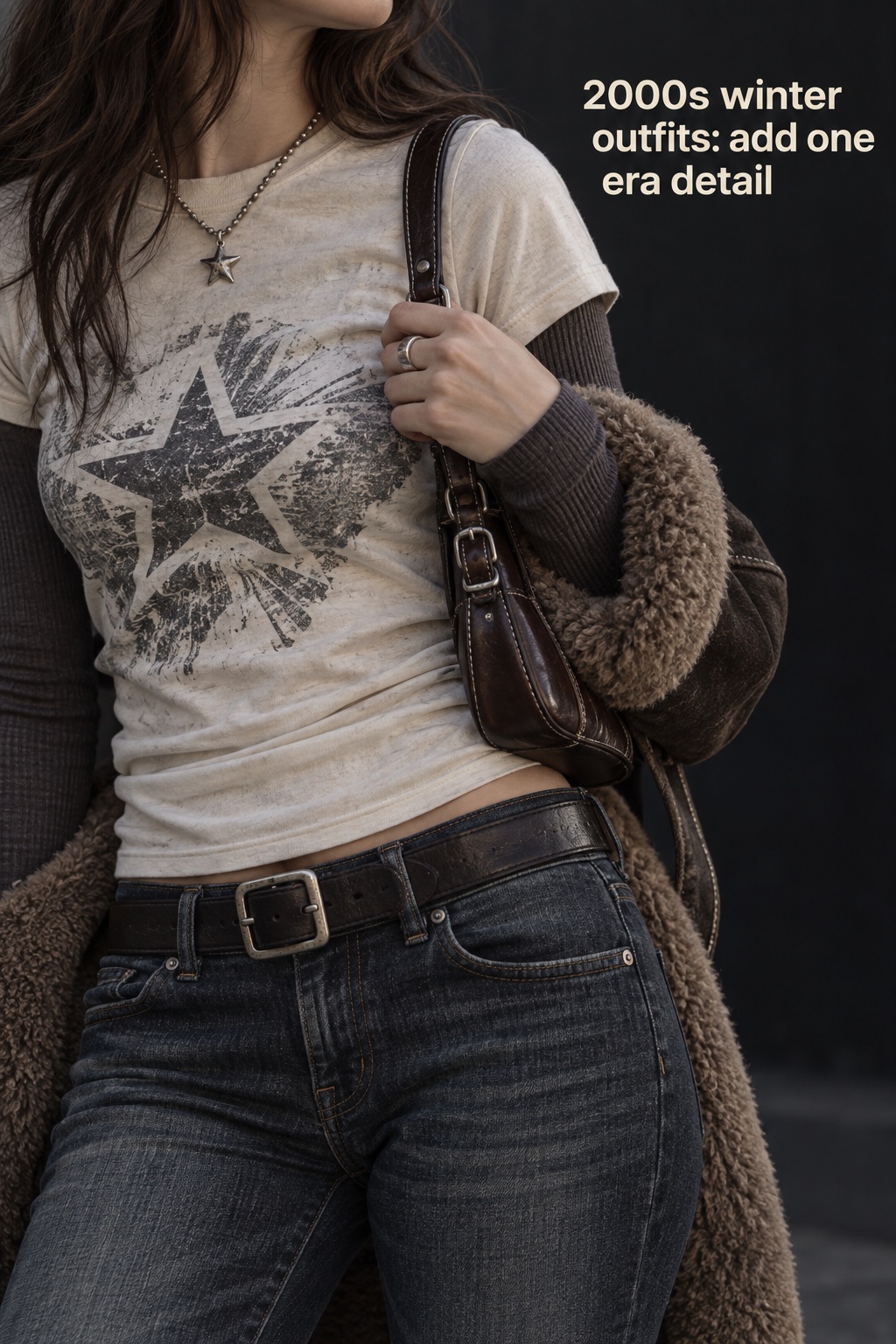 2000s winter outfits close-up with layered tee, belt, denim, and shoulder bag