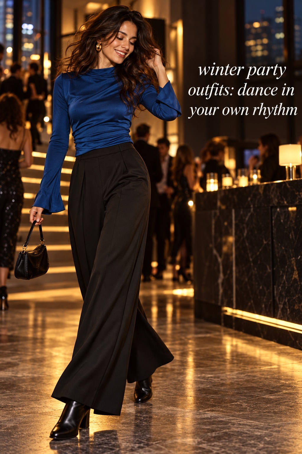 winter party outfits for dancing in a blue top and fluid black trousers