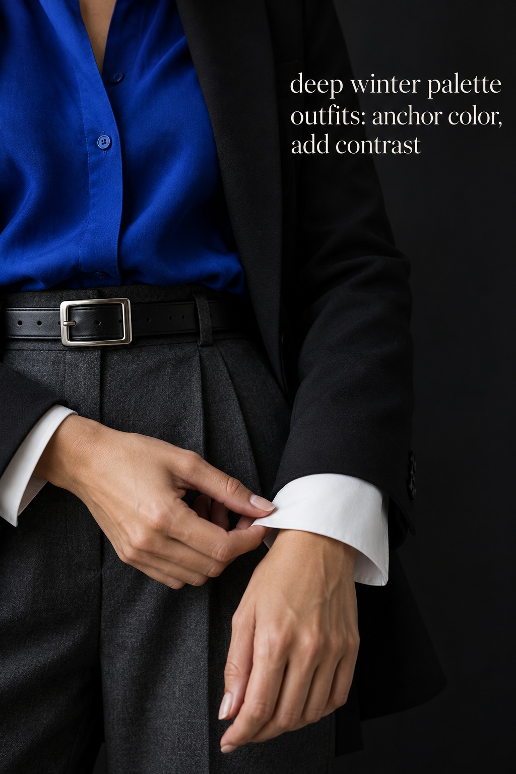 Deep winter palette outfits detail with cobalt blouse, charcoal trousers, black blazer, and crisp white cuff