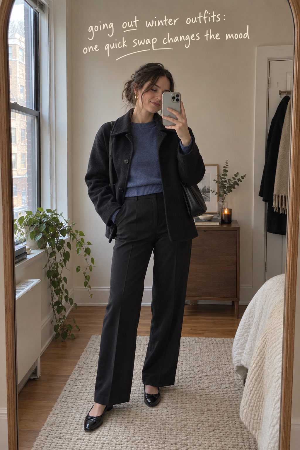 going out winter outfits in a candid mirror photo with blue knit and relaxed trousers