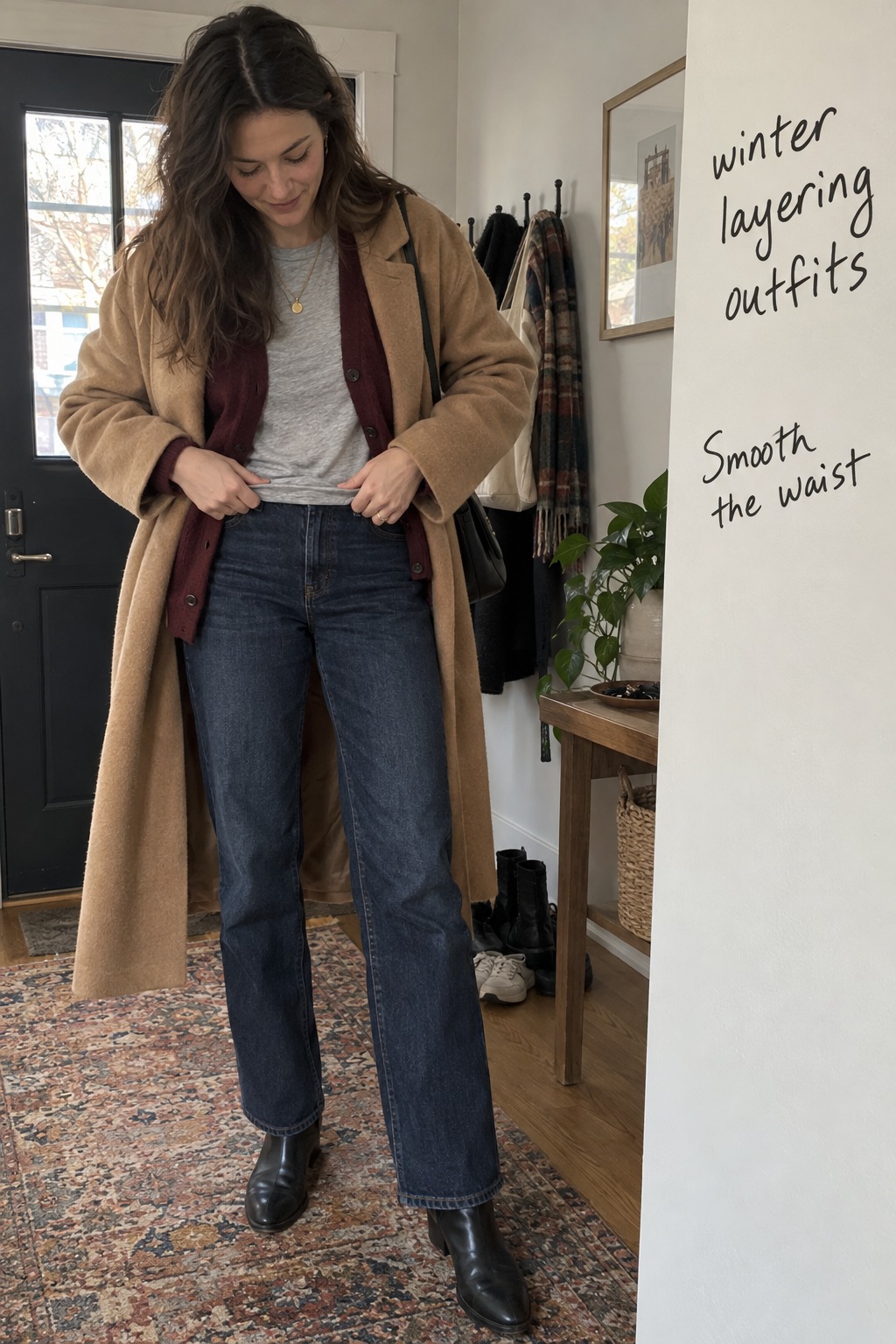 winter layering outfits candid generated look as a woman smooths a gray tee under a burgundy cardigan